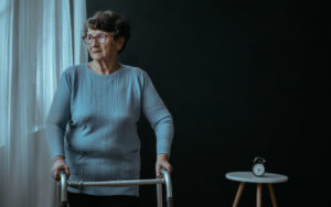 Elderly woman looks out the window, contemplates assisted suicide